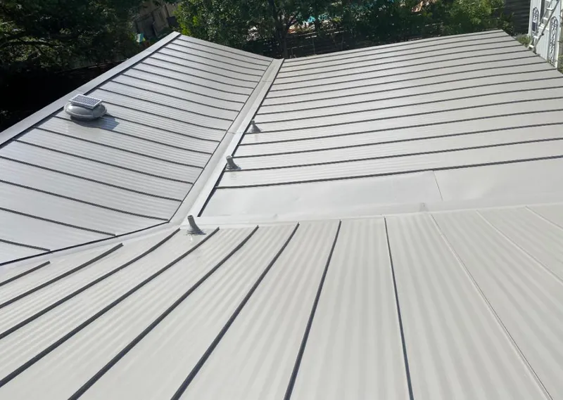 Solar attic fan installed on a metal roof for Roof Ventilation in Newtown